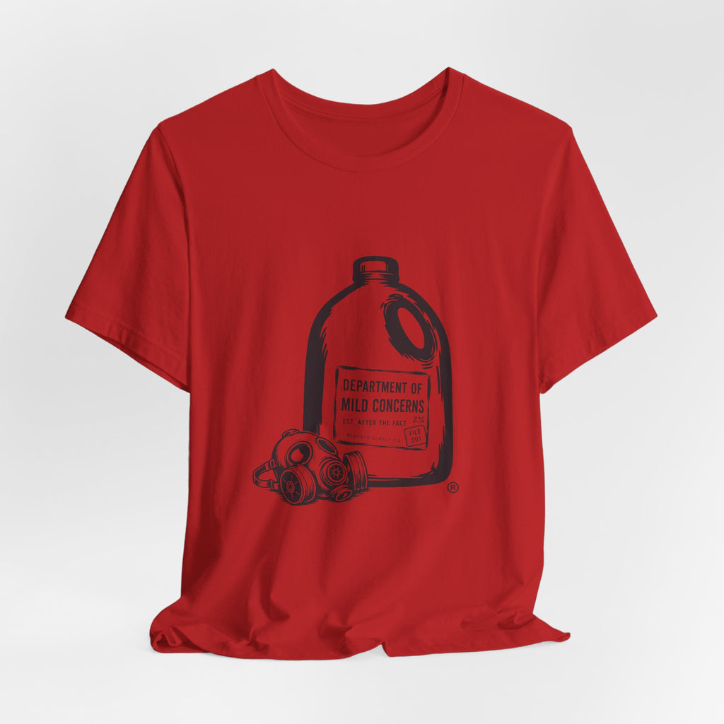Red t-shirt laid flat with a large gallon milk jug graphic with a gas mask and "Department of Mild Concerns" label