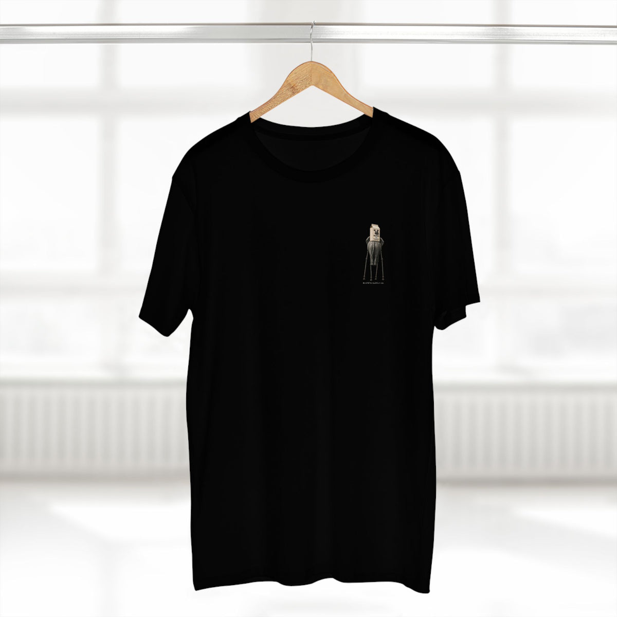 Stay Upwind Tee in black on a hanger, front: small left-chest elephant