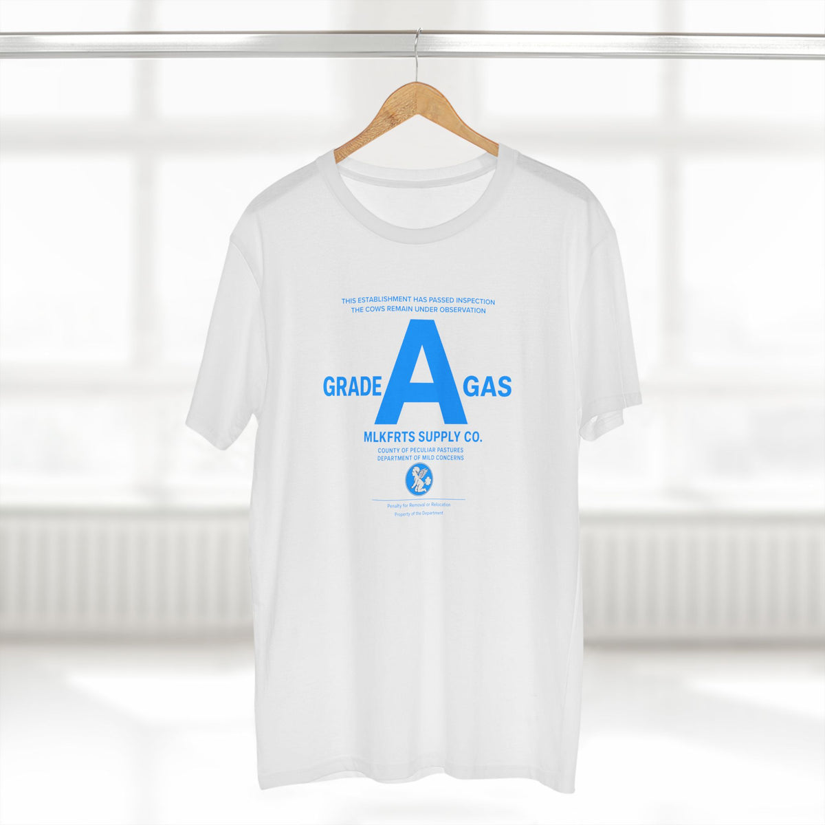 MLKFRTS Grade A Fully Compliant tee in White on a hanger, front view with the bright 2% blue Grade A compliance notice