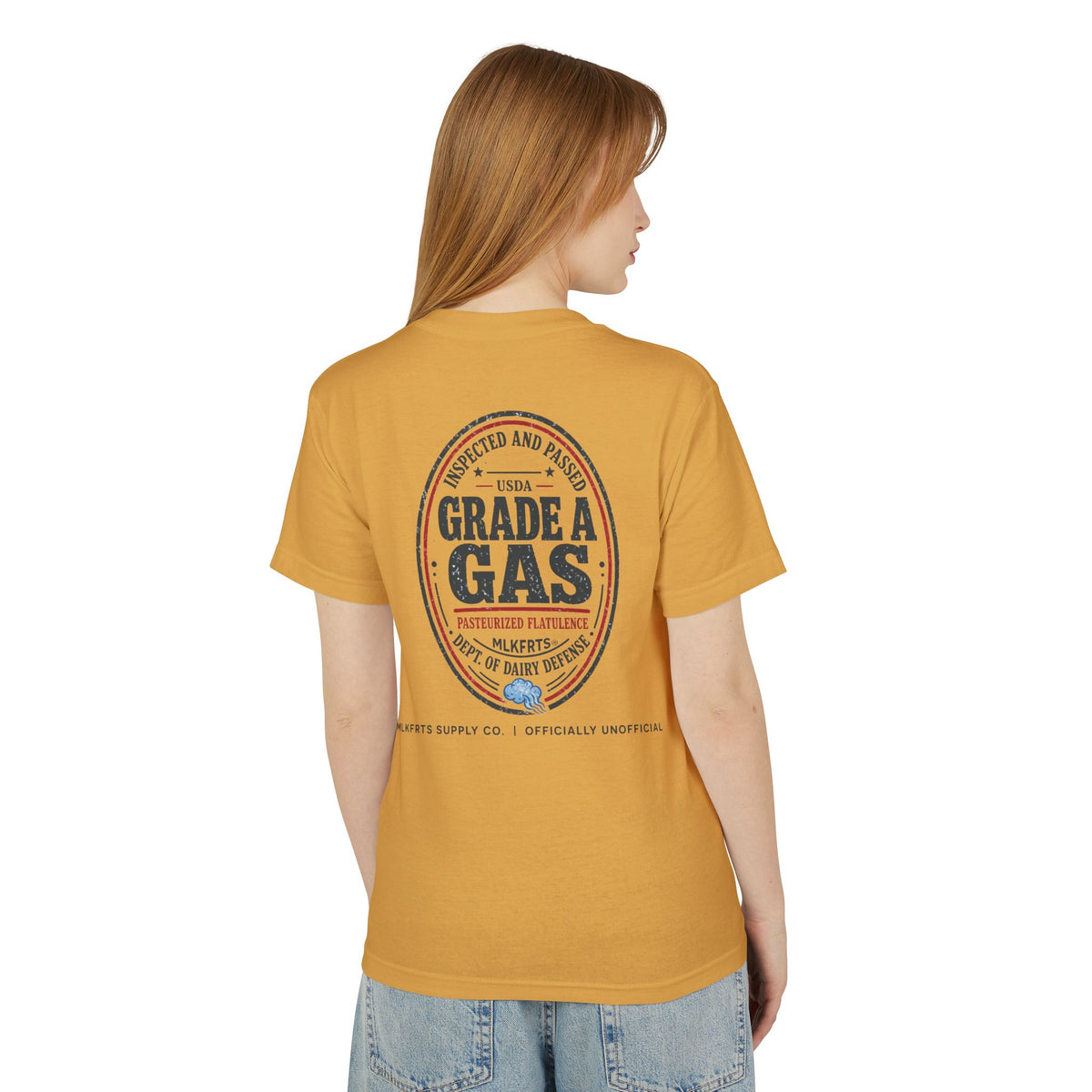 Model wearing the Faded Mustard garment-dyed t-shirt, back view with a large oval "Grade A Gas" seal