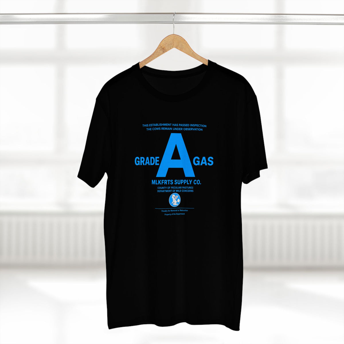 MLKFRTS Grade A Fully Compliant tee in Black on a hanger, front view with the bright 2% blue Grade A compliance notice