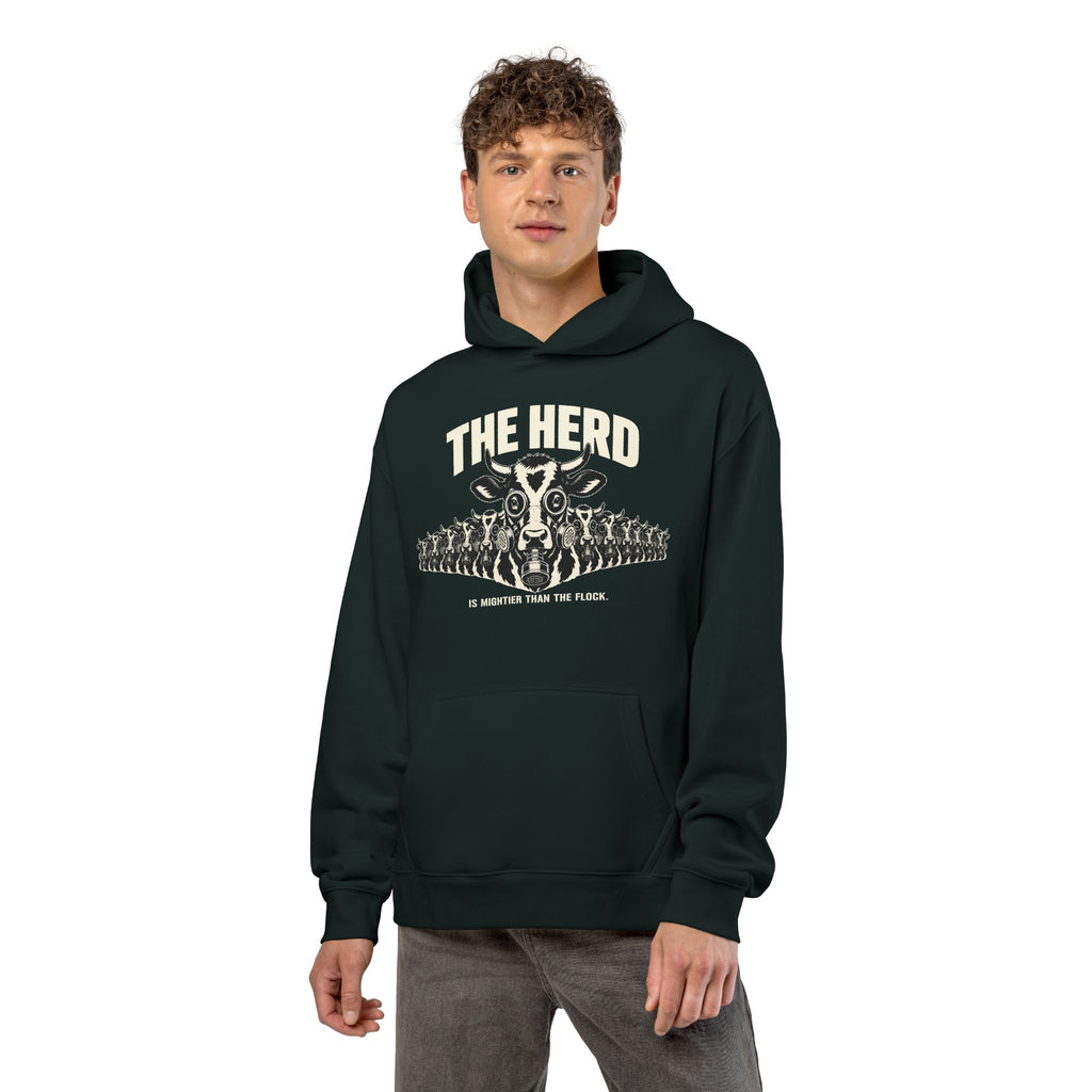 Man wearing the Stampede Hoodie in pine green, front: gas-mask cow stampede, THE HERD