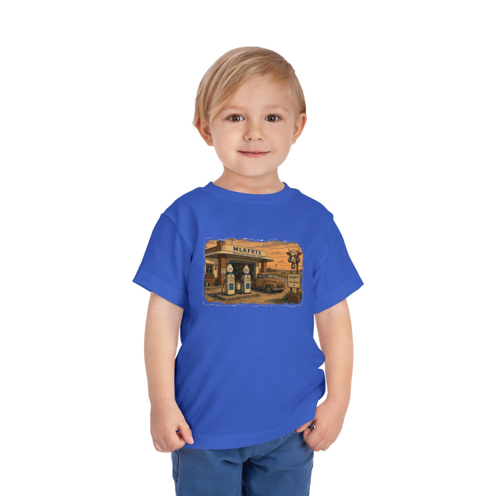 Toddler wearing the Peculiar Gas Station Toddler Tee in True Royal, gas station scene on the front