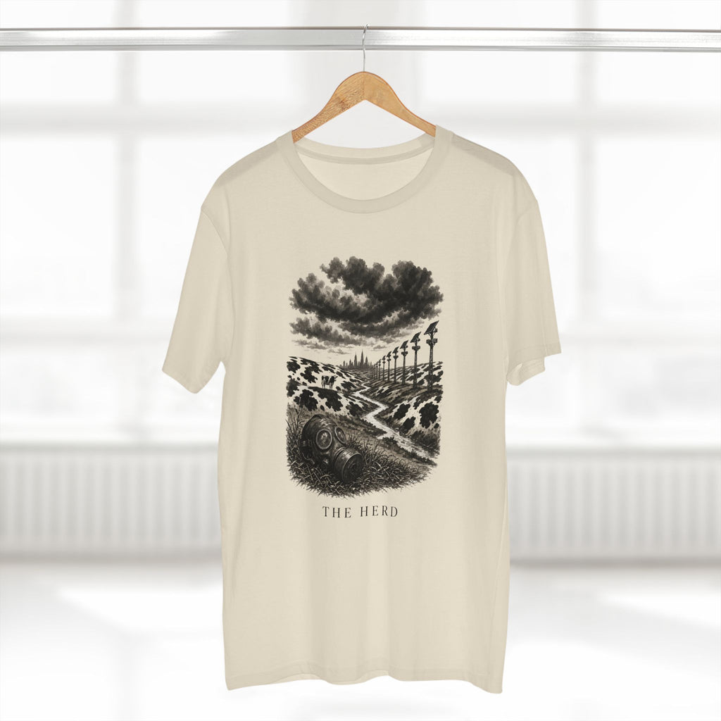 The Hills Have Cams Tee in natural on a hanger, front: etched surveillance hills with a gas mask in the grass, THE HERD.