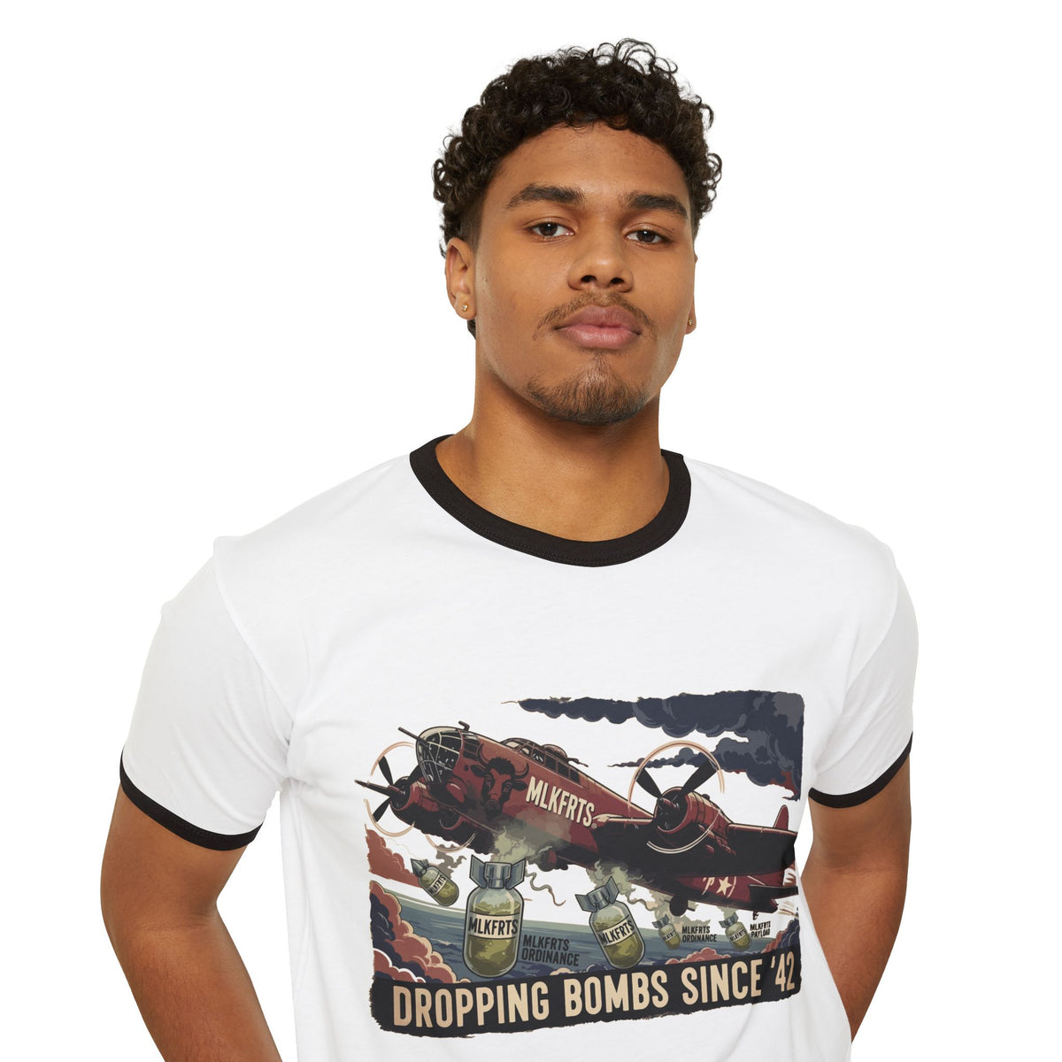 Model wearing the White/Black ringer tee with a "Dropping Bombs Since '42" illustration of a bomber plane dropping milk jugs, front view