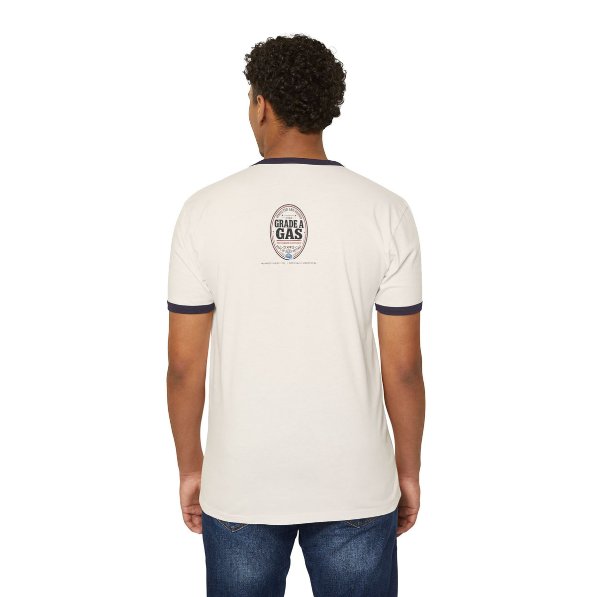 Model wearing the Natural/Midnight Navy ringer tee, back view with a small oval seal on the upper back