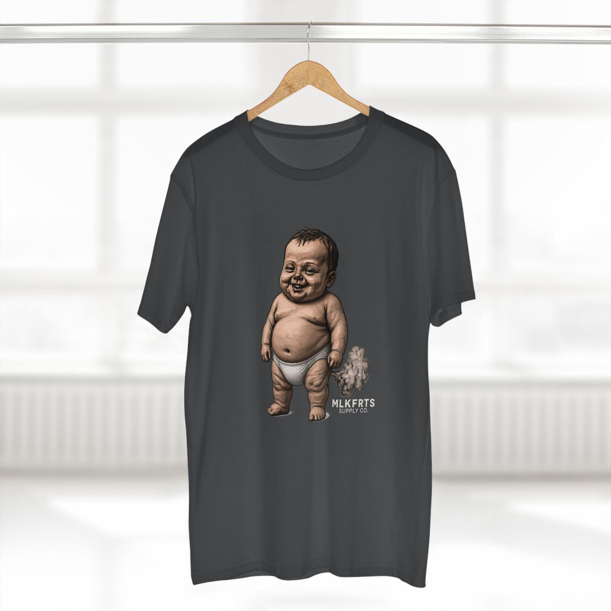 Charcoal MLKFRTS Lil' Stinker Tee on a hanger, smug diaper baby with gas cloud and milk puddles on the front