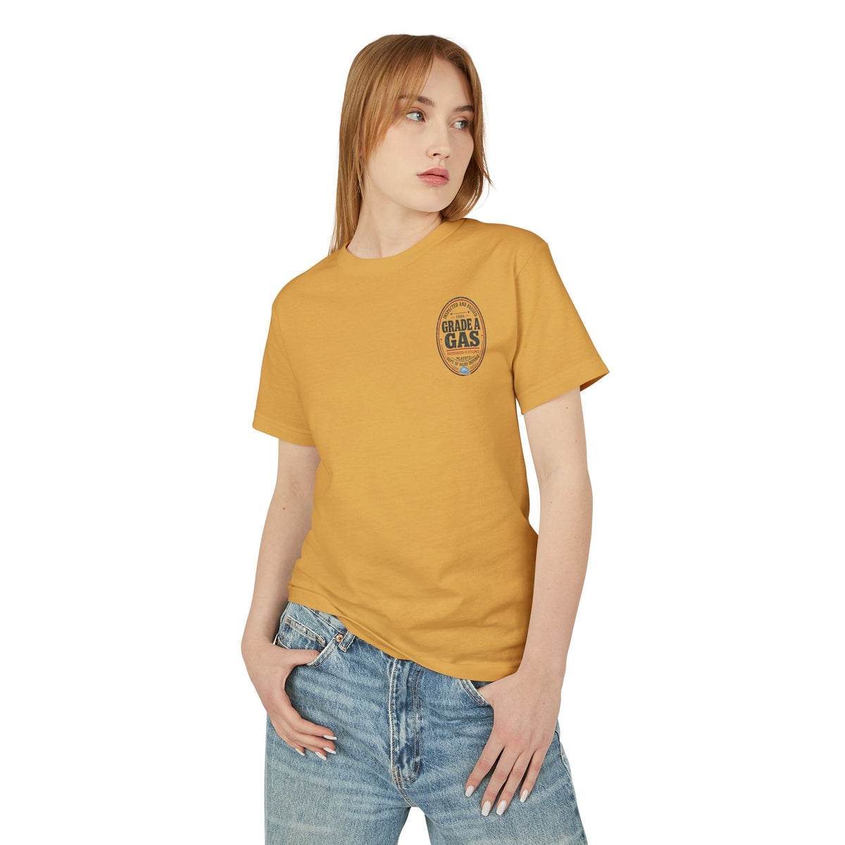 Model wearing the Faded Mustard garment-dyed t-shirt with a small oval "Grade A Gas" seal on the left chest, front view