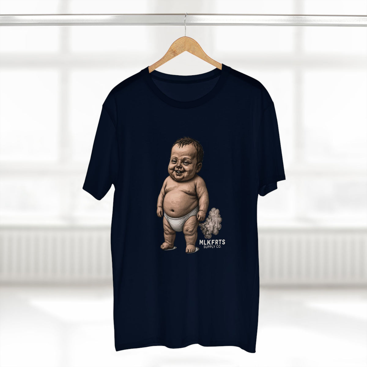 Navy MLKFRTS Lil' Stinker Tee on a hanger, smug diaper baby with gas cloud and milk puddles on the front