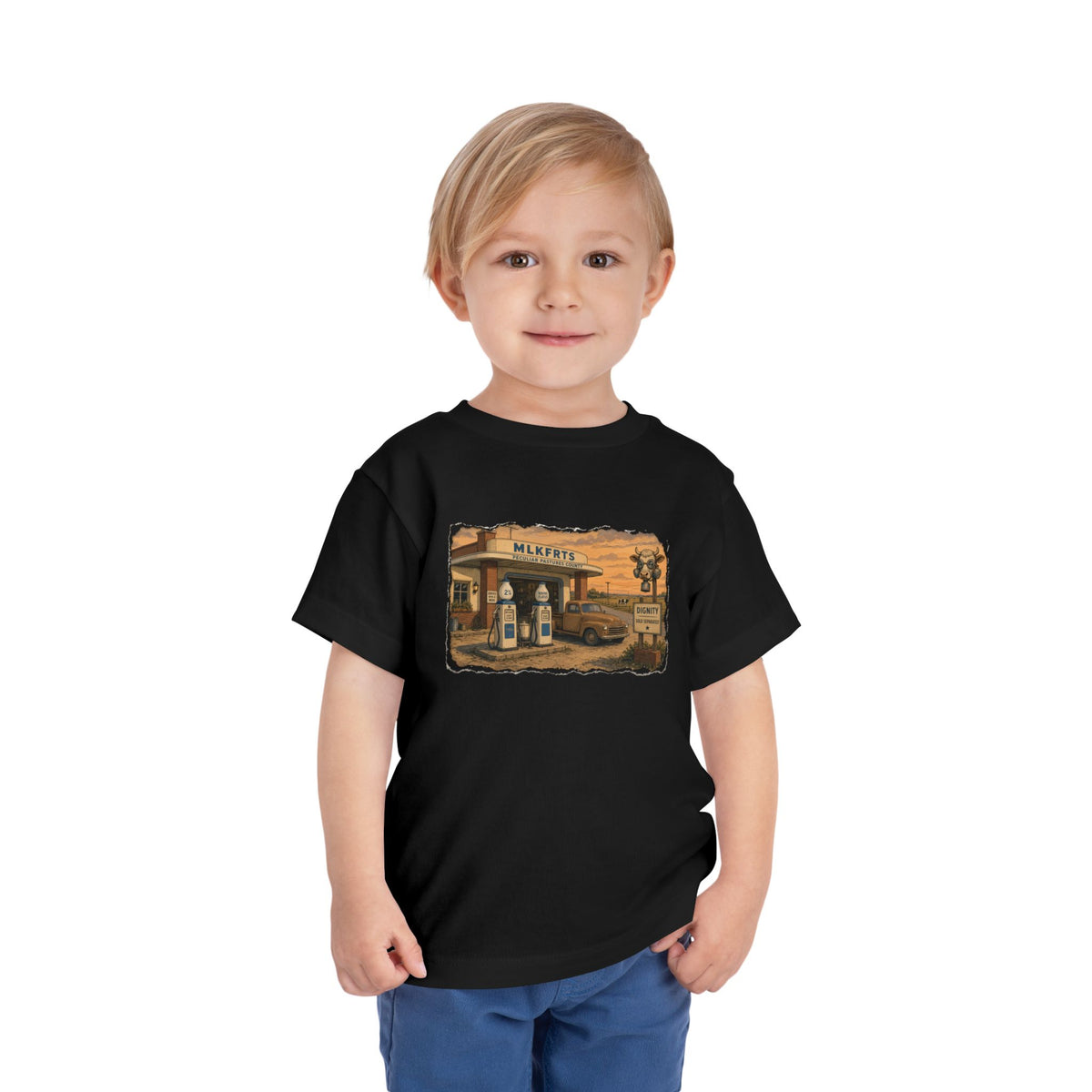 Toddler wearing the Peculiar Gas Station Toddler Tee in Black, gas station scene on the front