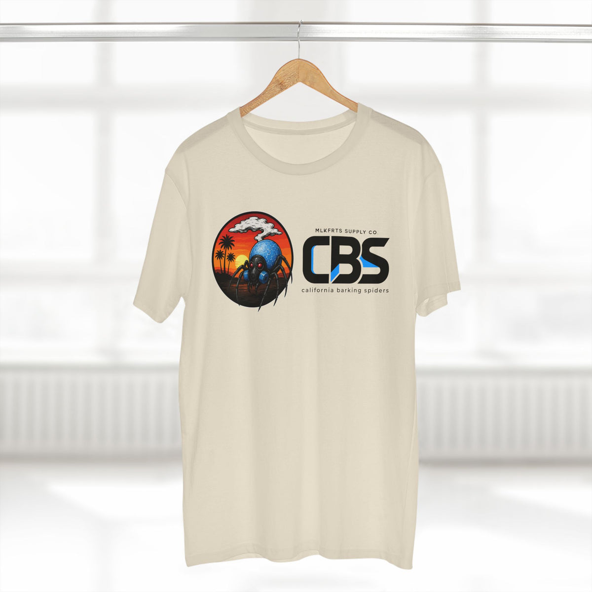 MLKFRTS California Barking Spiders Tee in natural on a hanger, front: CBS lockup with the gas-masked spider