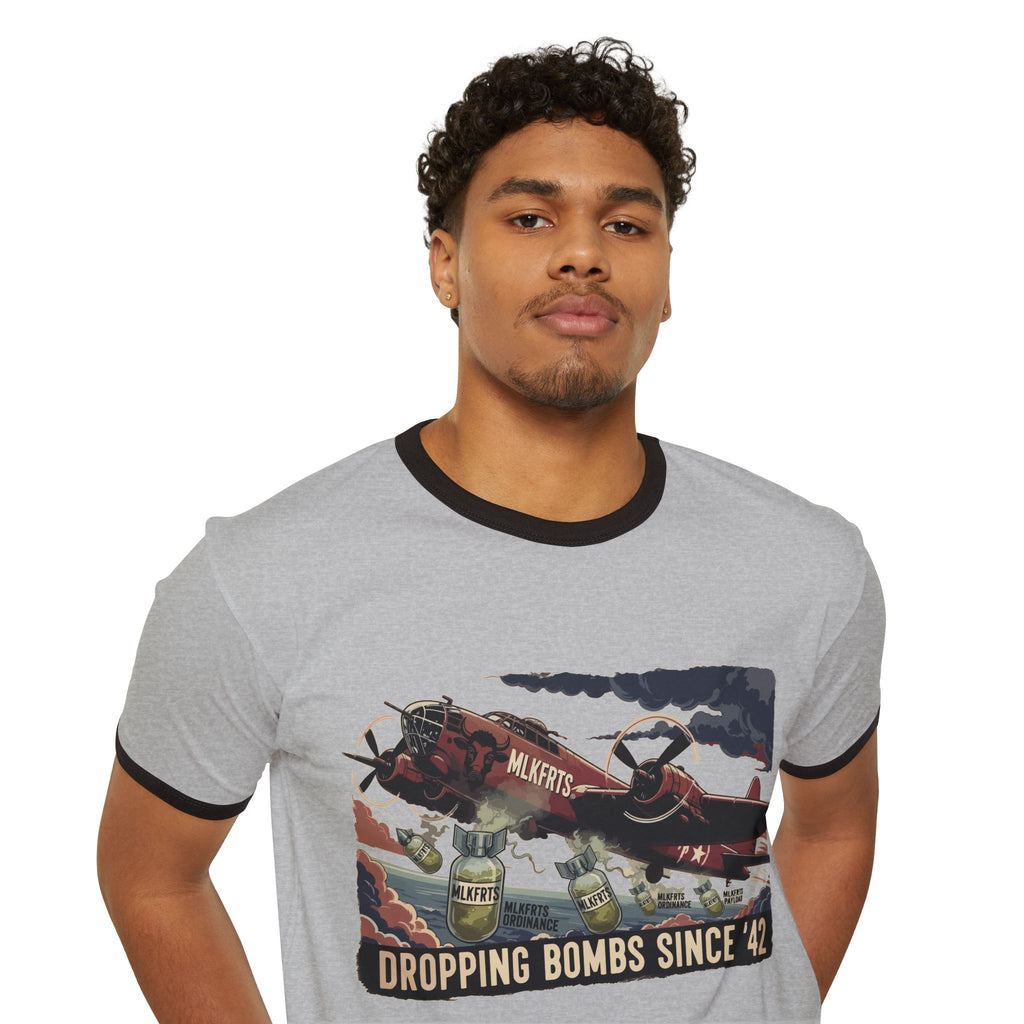 Model wearing the Heather Grey/Black ringer tee with a "Dropping Bombs Since '42" illustration of a bomber plane dropping milk jugs, front view