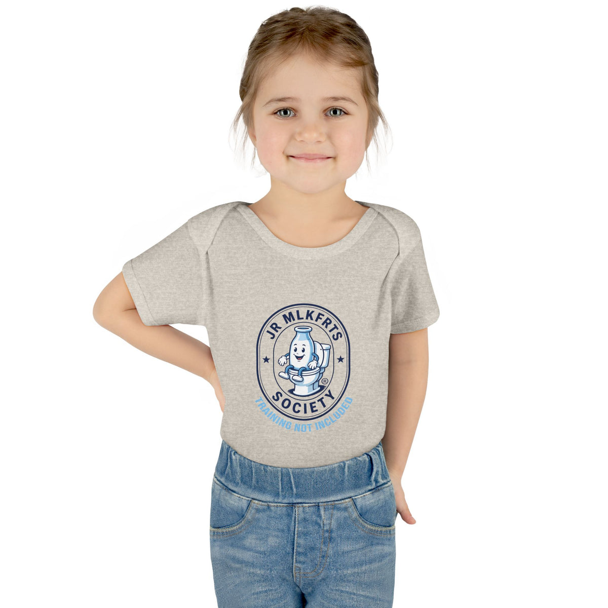 Baby wearing the Natural Heather baby bodysuit with a round Jr. MLKFRTS Society badge print with a cartoon milk bottle
