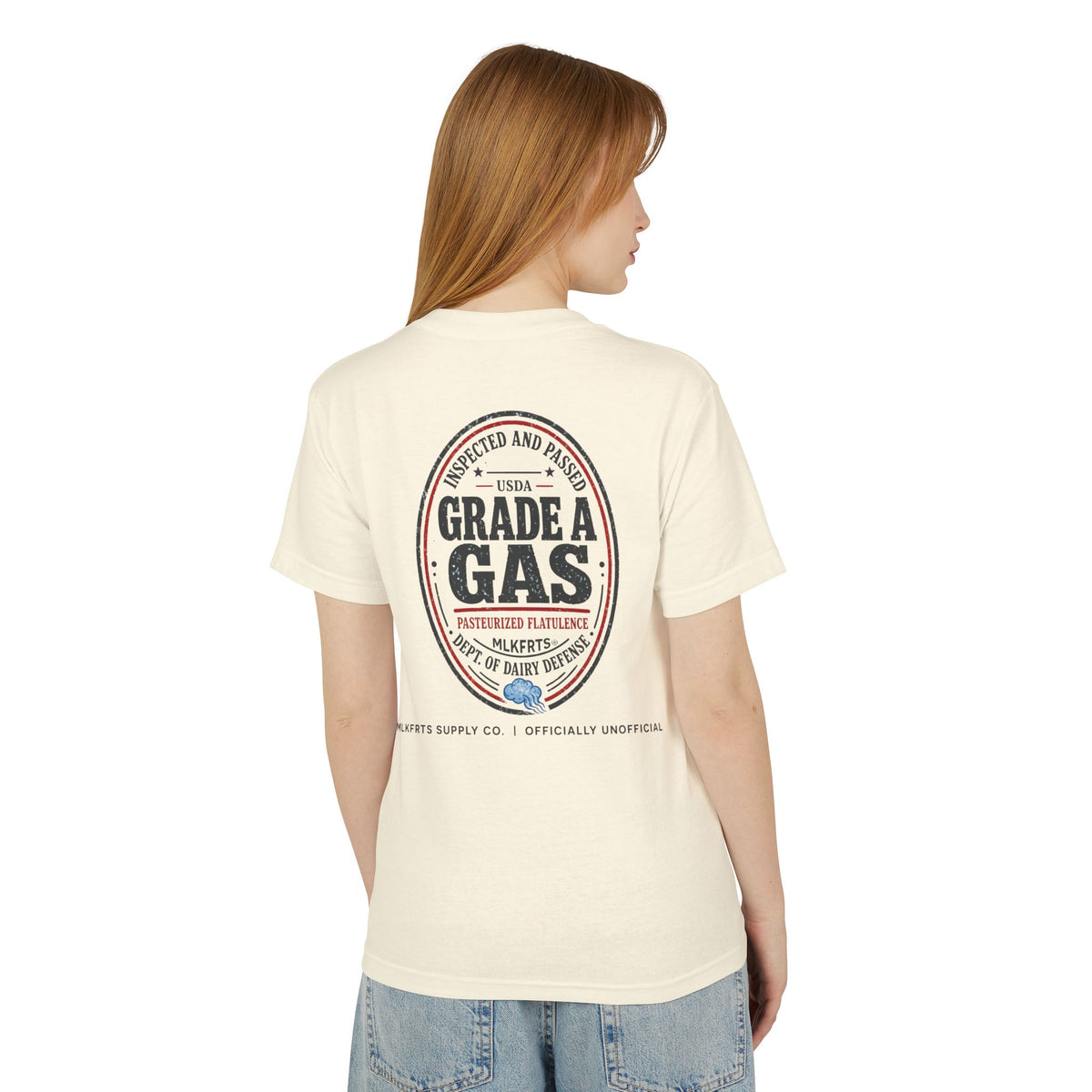 Model wearing the Faded Cream garment-dyed t-shirt, back view with a large oval "Grade A Gas" seal