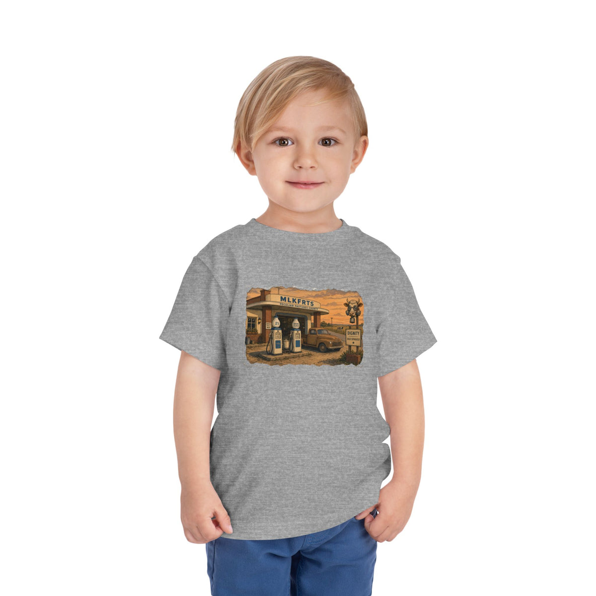 Toddler wearing the Peculiar Gas Station Toddler Tee in Athletic Heather, gas station scene on the front